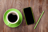 Smartphone and green coffee cup
