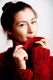 young pretty woman in sweater and scarf all over her face