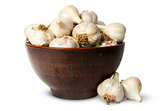 Whole head of garlic in ceramic bowl