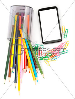 Fallen pencil cup with crayons and smartphone