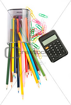 Fallen pencil cup with crayons and calculator