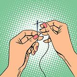 Needlework seamstress threads the needle