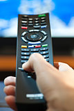 Hand with television remote control