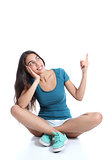 Teenager girl sitting and pointing at side
