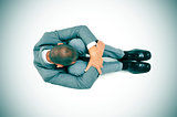 businessman curled up in the floor with his head between his kne