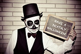 man with calaveras makeup, with chalkboard with text have a deat