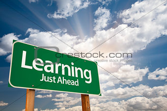 Learning Green Road Sign Over Clouds