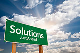 Solutions Green Road Sign Over Clouds