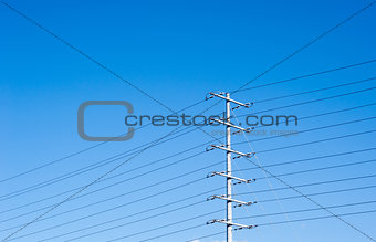 Electrical tower on blue sky with many power lines