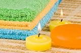 Towels of different colours soap and candles