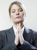Praying businesswoman