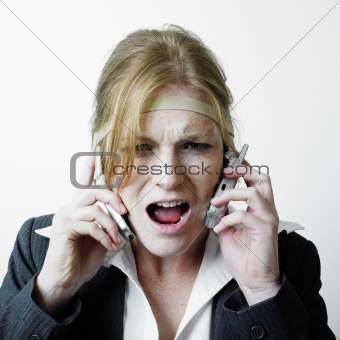 Stressed woman on two phones