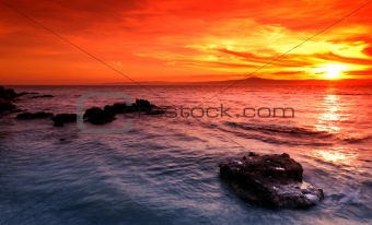 Amazing sunset over rocky seascape