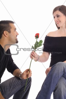 latino man giving woman a rose isolated on white