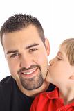 shot of a little boy kissing father