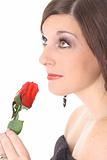 brunette smelling a rose looking up isolated on white
