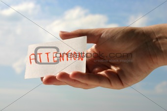 hand holding attention card