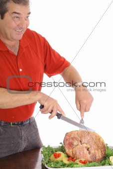 Man slicing a delicious ham isolated on white