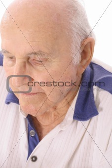 shot of an elderly man looking down depressed