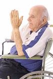 handicap senior praying in wheelchair isoalted on white