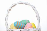 Easter eggs in a white wicker basket