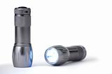 Two silver flashlights isolated on white background with clipping path. One flashlight is in focus the other is not.
