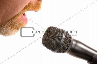 Bearded man speaking into a microphone with only cheeks and mouth visible. Isolated on white background.