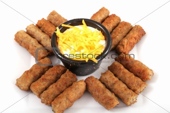 shot of sausages with a cheese dipping sauce