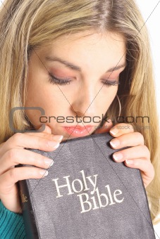 beautiful woman looking at holy bible isolated on white