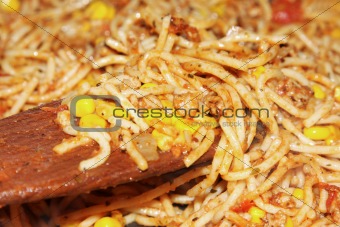 spaghetti on wooden spatula