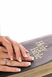 shot of a female hands on a bible