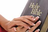 shot of  female hands on holy bible