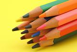 bunch of colorful pencils on yellow