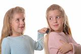 shot of twin child brushing sisters hair