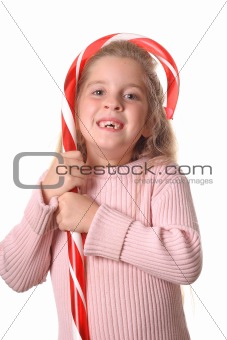 shot of a little girl with candy cane vertical