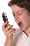 shot of a young boy yelling into cellphone