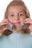shot of a young girl talking on two cellphones