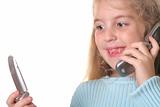 shot of a happy young girl talking on a cell phone looking at another phone