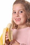 shot of a little girl eating a banana