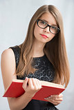 Teenage girl in glasses with  books