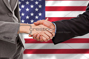 Composite image of close up of two businesspeople shaking their hands