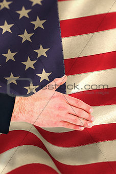 Composite image of hand of businessman offering handshake