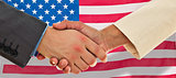 Composite image of closeup of shaking hands over eye glasses and diary