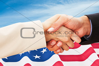 Composite image of close up on partners shaking hands