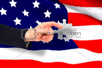 Composite image of hand of businessman in suit pointing