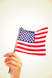Composite image of hand waving american flag