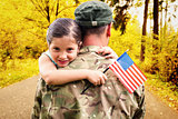Composite image of soldier reunited with his daughter