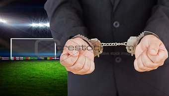 Composite image of handcuffed businessman