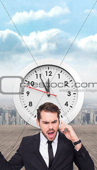 Composite image of angry businessman gesturing on the phone