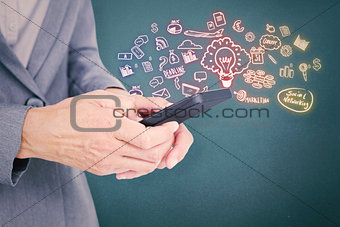 Composite image of  businesswoman looking at her smartphone